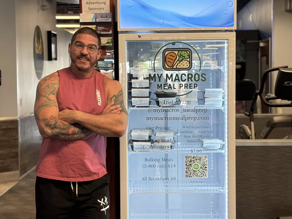 Owner in front of fridge.